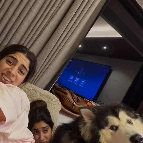 In the next picture, Janhvi joined her, and the sisters ended up stuck under their happily resting pet, creating a moment tha